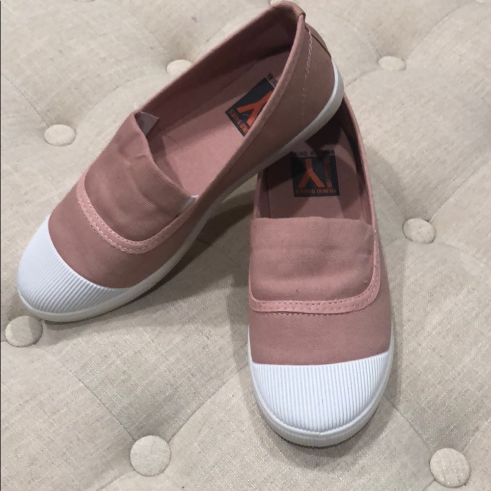 Pink canvas sneakers with white rubber tips